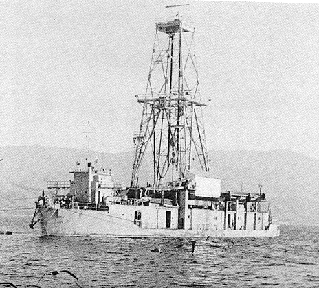 CUSS 1, a converted World War II barge, built by Continental, Union, Shell, and Superior oil companies for offshore drilling.