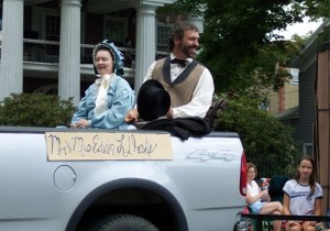 Titusville oil parade with "Mr. and Mrs. Edwin Drake" in back of pickup truck.
