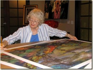 JoAnn Cowans inspects one of her large prints.